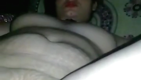 Indian slut in pink dress is on a bed showing her body